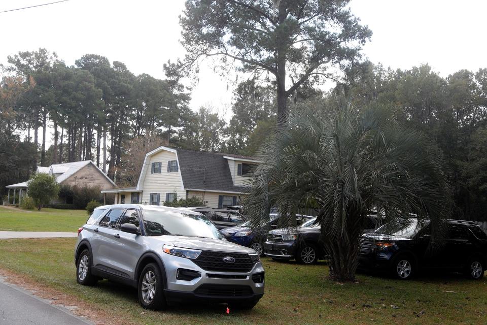 Vehicles from various law enforcement and other agencies sit outside the Buckhalter Road home where Quinton Simon was last seen before his disappearance.