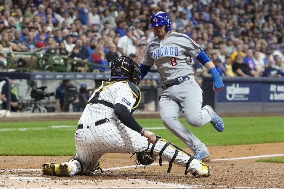 Milwaukee Brewers catcher Victor Caratini tags out Chicago Cubs' Ian Happ at home during the fourth inning of a baseball game Saturday, Sept. 30, 2023, in Milwaukee. (AP Photo/Morry Gash)