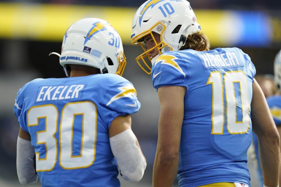 Chargers quarterback Justin Herbert, right, talks to running back Austin Ekeler.