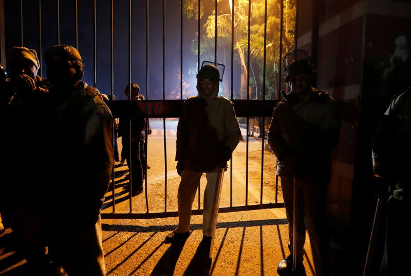 Police in riot gear stand guard outside the Jawaharlal Nehru University (JNU) after clashes between students in New Delhi