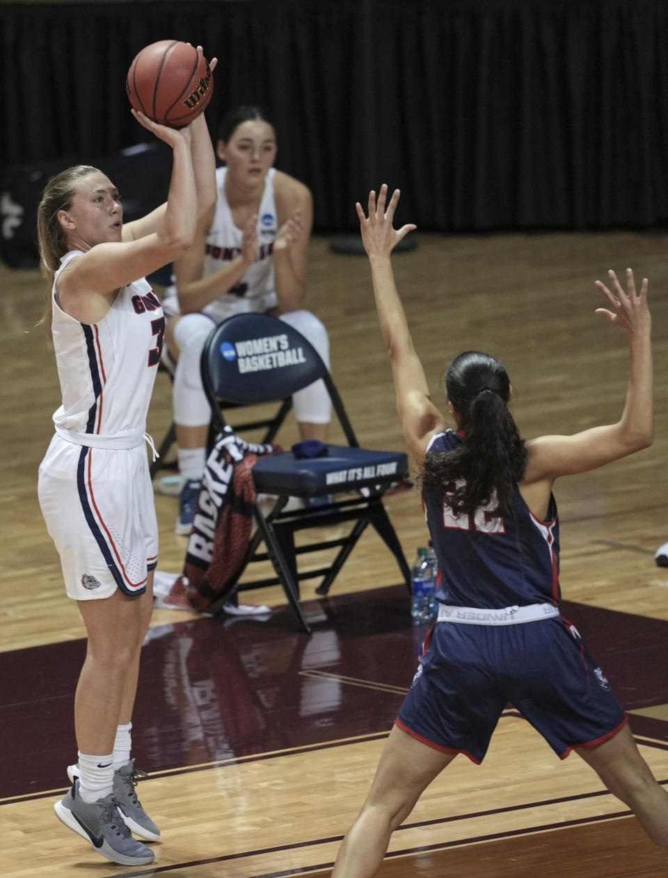 Gonzaga's Jill Townsend shoots as Belmont's Maddie Cook (22) defends during the second half of a college basketball game in the first round of the NCAA women's tournament at University Events Center in San Marcos, Texas, Monday, March 22, 2021. (AP Photo/Chuck Burton)