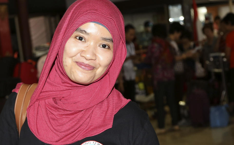 In this April 10, 2014 photo, Yulveri, who arrived for her China Airlines flight to Hokkaido, poses for a photo after an interview at Soekarno-Hatta International Airport in Jakarta, Indonesia. At airports across Asia and around the world, Flight 370 and its 239 passengers and crew, now lost for more than a month, are topics of avid speculation and sometimes anxiety. Passengers typically remain confident about the safety of air travel, but some are distressed by the disappearance, which - given the number of people involved - is unprecedented in aviation industry. (AP Photo/Tatan Syuflana)