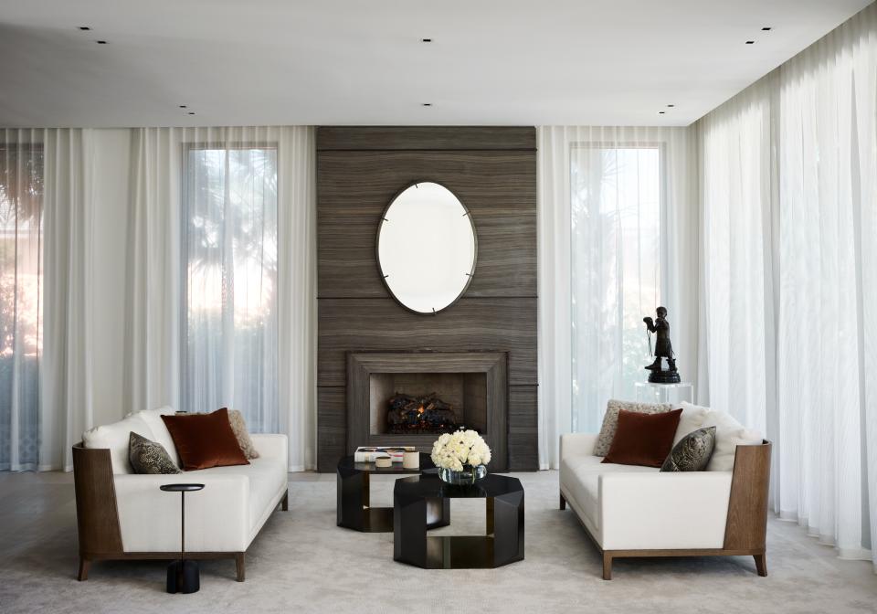 Joyner’s family room is both sleek and cozy. The fireplace area is constructed of open-pore onitis marble with bronze inserts and was custom designed by Wecselman Design. The love seats are by Liaigre, the coffee table is from Donghia, and the rug was another custom design, this one from Tai Ping.