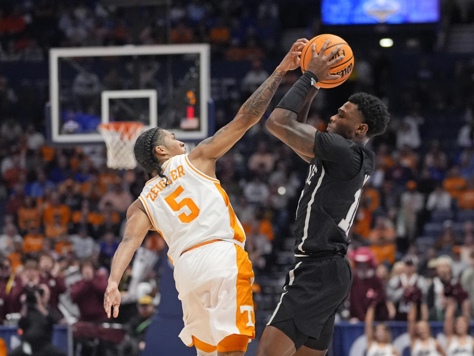 Tennessee guard Zakai Zeigler (5) tries to steal the ball from Mississippi State guard Dashawn Davis (10) during the first half of an NCAA college basketball game at the Southeastern Conference tournament Friday, March 15, 2024, in Nashville, Tenn. (AP Photo/John Bazemore)