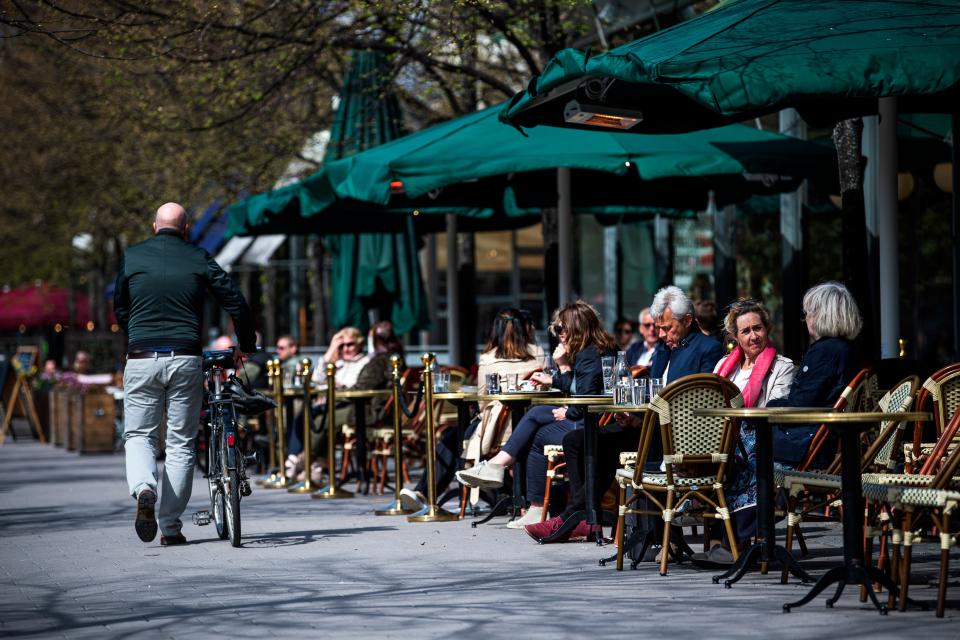 People sit in a restaurant in Stockholm on May 8, 2020, amid the coronavirus COVID-19 pandemic. (Photo by Jonathan NACKSTRAND / AFP) (Photo by JONATHAN NACKSTRAND/AFP via Getty Images)