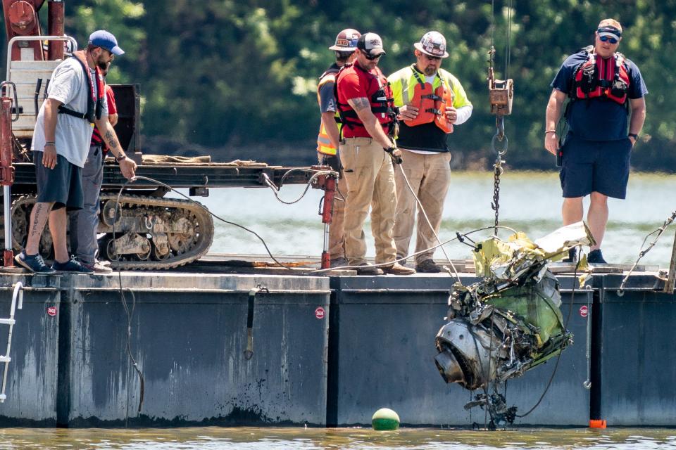 Wreckage is pulled from the water at the scene of the plane crash Monday.