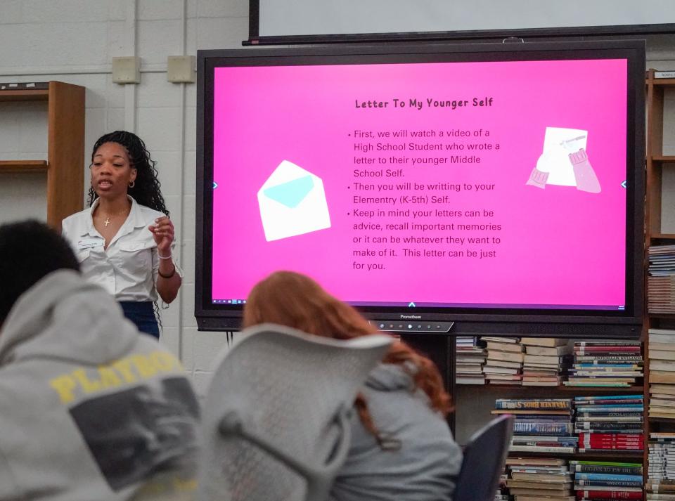 DeOndra Craig, a K-8 program coordinator for Girls Inc. of Greater Indianapolis leads Northwest Middle School students in writing letters to their younger selves during a special session of Girls, Inc. on Thursday, April 18, 2024, at N.M.S in Indianapolis. Girls, Inc. is a national nonprofit that centers around providing programming for empowering young girls.