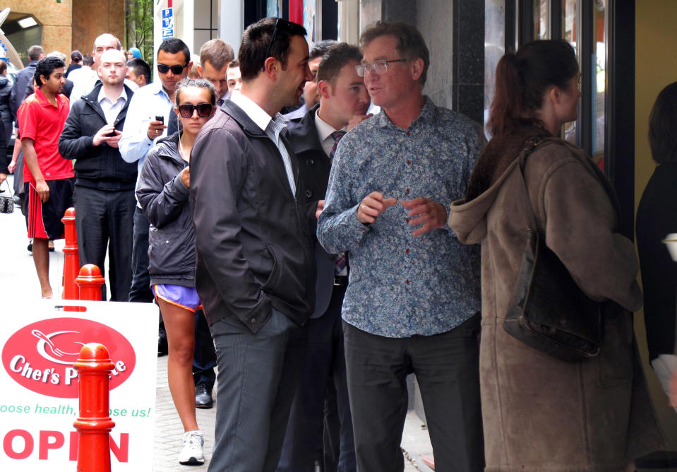 FILE- In this Tuesday, Jan. 28, 2014 file photo, workers queue to get take-out lunches at the Chef's Palette eatery in Wellington, New Zealand. New Zealand’s Reserve Bank raised its benchmark interest rate by quarter of a percentage point to 2.75 percent after holding it at a record low for three years. The bank indicated it plans to continue raising rates to about 5 percent by March 2017. (AP Photo/Nick Perry, File)