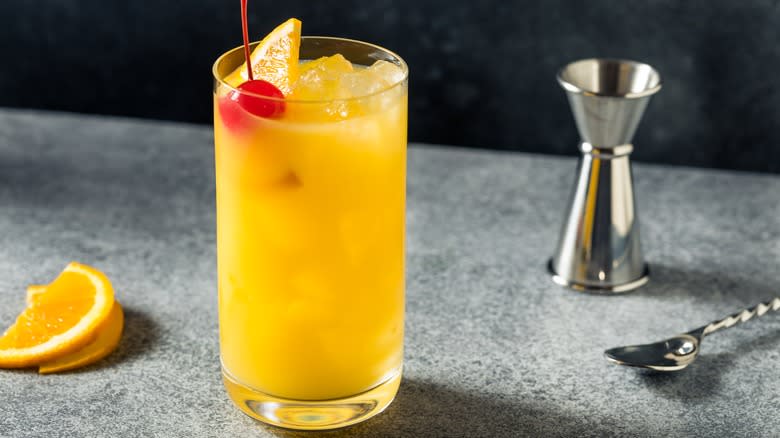 screwdriver cocktail, jigger and bar spoon