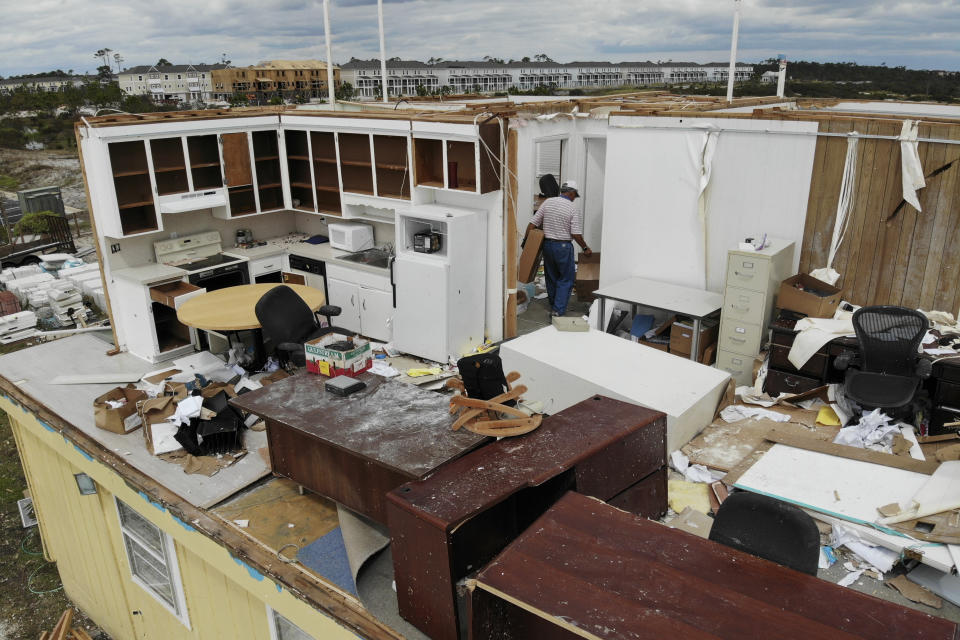 Joe Mirable surveys the damage to his business after Hurricane Sally moved through the area, Thursday, Sept. 17, 2020, in Perdido Key, Fla. Rivers swollen by Hurricane Sally's rains threatened more misery for parts of the Florida Panhandle and south Alabama on Thursday, as the storm's remnants continued to dump heavy rains inland that spread the threat of flooding to Georgia and the Carolinas. (AP Photo/Angie Wang)