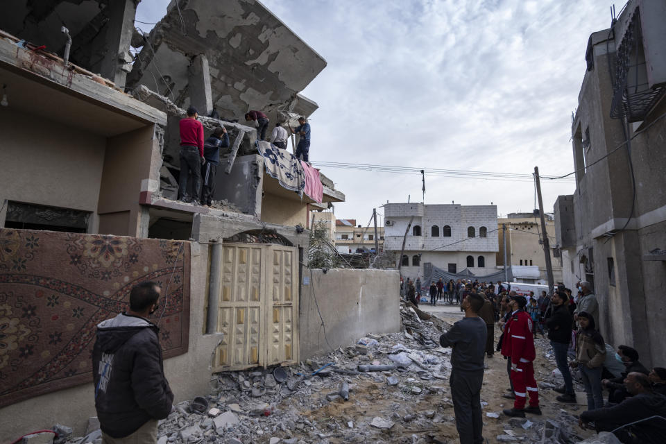 Palestinians search for bodies at a house hit by an Israeli strike in Rafah, Gaza Strip on Wednesday, March 27, 2024. (AP Photo/Fatima Shbair)