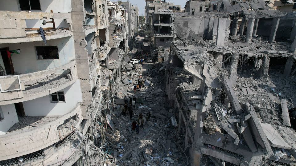 Palestinians look for survivors after an Israeli airstrike in Deir al-Balah, Gaza, on Sunday. - Hatem Moussa/AP