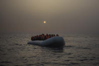 <p>African refugees and migrants, mostly from Sudan and Senegal, wait aboard a rubber boat out of control to be assisted by an NGO, 25 miles north of Sabratha, off the Libyan coast, early in the morning on Feb. 23, 2016. (Photo: Santi Palacios/AP) </p>