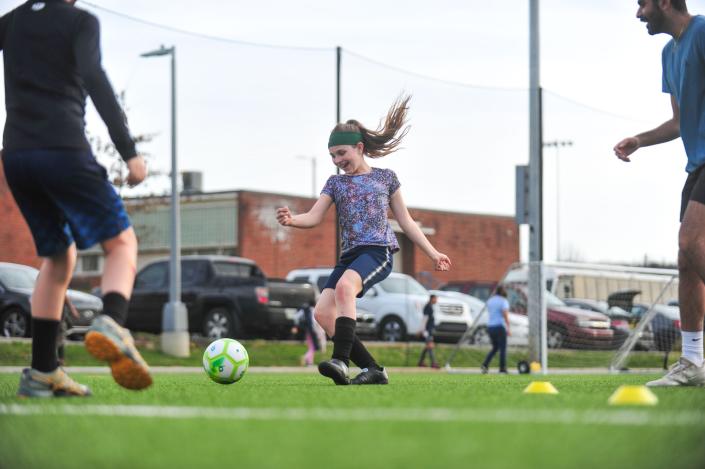 A child winds up to kick the ball during passing drills Emerald Youth Sports Complex in Lonsdale.