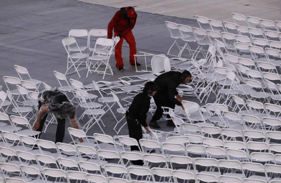 <p>Workers rearrange chairs after they were blown over by the wind before the start of the Summer Olympics closing ceremony inside Maracana stadium in Rio de Janeiro, Brazil, Sunday, Aug. 21, 2016. (AP Photo/Jae C. Hong) </p>