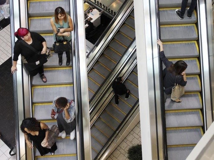 Shoppers ride escalators at the Beverly Center mall in Los Angeles, California November 8, 2013. REUTERS/David McNew 