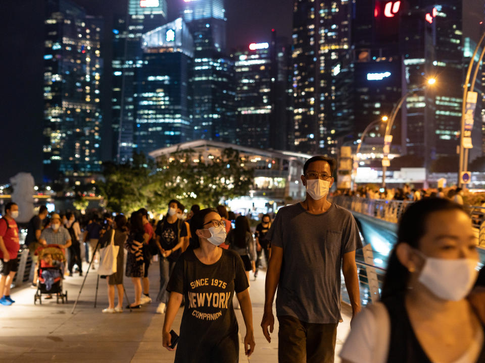 People flock to the Marina Bay area to watch light shows to usher in the new year amid the COVID-19 pandemic in Singapore on January 1, 2021. (PHOTO: Zakaria Zainal/Anadolu Agency via Getty Images)