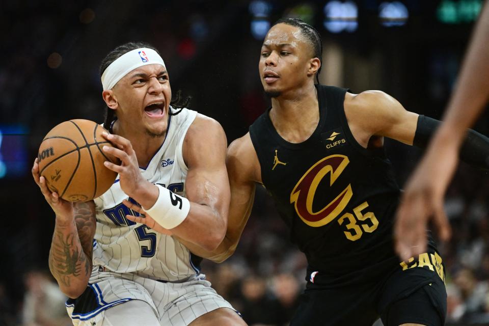 Magic forward Paolo Banchero drives against Cavaliers forward Isaac Okoro during the first half in Game 7 of a first-round playoff series, May 5, 2024, in Cleveland.
