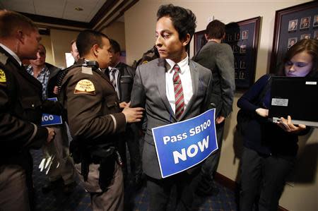 LGBT rights activist are detained by members of the Utah Highway Patrol after blocking a Senate committee hearing room at the Utah State Capitol, February 10, 2014, in Salt Lake City, Utah. REUTERS/Jim Urquhart