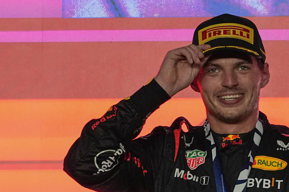 Red Bull driver Max Verstappen of the Netherlands smiles on the podium after winning the Qatar Formula One Grand Prix auto race at the Lusail International Circuit, in Lusail, Qatar, Sunday, Oct. 8, 2023. (AP Photo/Ariel Schalit)