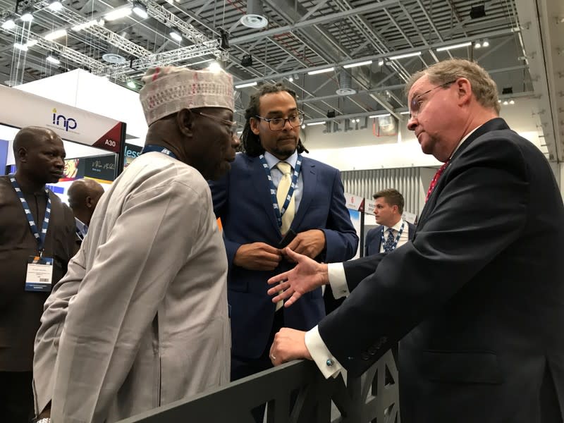 U.S. Assistant Secretary for Fossil Energy at the department of energy Steven Winberg speaks to former Nigerian President Olusegun Obasanjo at the Africa Oil Week conference in Cape Town