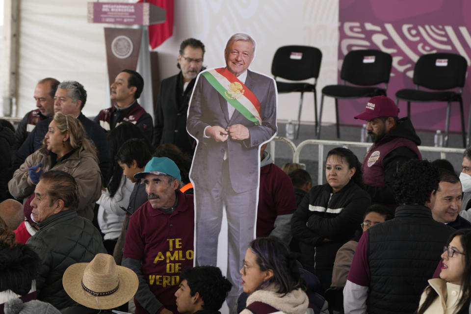 Supporters of Mexican President Andrés Manuel López Obrador hold a life-size image of him during a ceremony to inaugurate a "mega-pharmacy" warehouse in Huehuetoca, Mexico, Dec. 29, 2023. It is the president's solution to help end a supply issue for hospitals that don't have specific medicines needed by patients. (AP Photo/Fernando Llano)