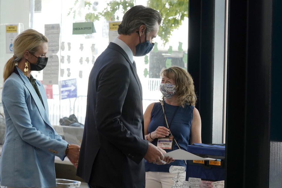 California Gov. Gavin Newsom, casts his ballot for the recall election at a voting center in Sacramento, Calif., Friday, Sept. 10, 2021. Newsom was accompanied by his wife, First Partner Jennifer, Siebel Newsom, left. The last day to vote in the recall election is Tuesday, Sept. 14. A majority of voters must mark "no" on the recall to keep Newsom in office. (AP Photo/Rich Pedroncelli)