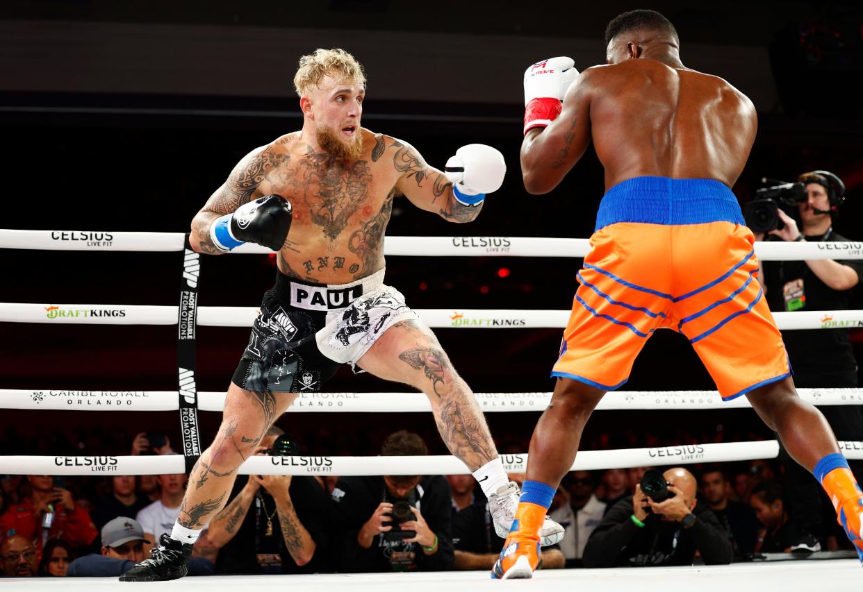 Jake Paul, left, punches Andre August during a December 2023 fight.