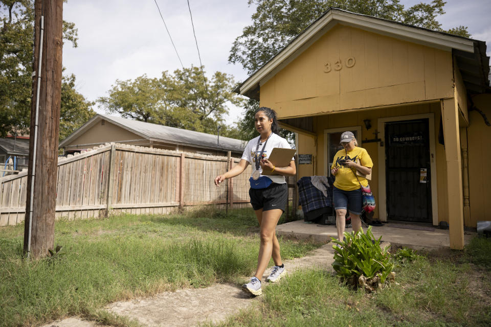 Uvalde mayoral candidate Kimberly Mata-Rubio, left, and campaign manager Dr. Laura Barberena, canvass a neighborhood in support of Mata-Rubio's campaign, Saturday, Oct. 21, 2023, in Uvalde, Texas. (AP Photo/Darren Abate)