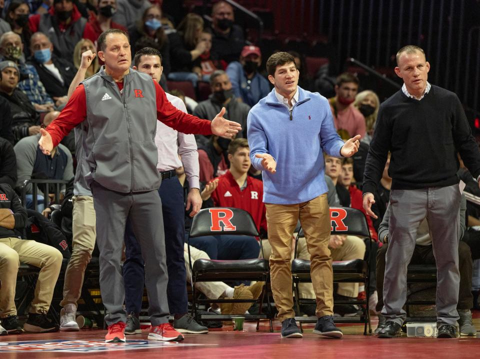 Rutgers head coach Scott Goodale (left) and assistant coaches Anthony Ashnault (center) and Donny Pritzlaff are pleading with the referee for a stalling call on Illinois' We Rachal during Rachal's bout with Rutgers 141-pounder Sebastian Rivera Friday night in Rutgers' 21-13 win.