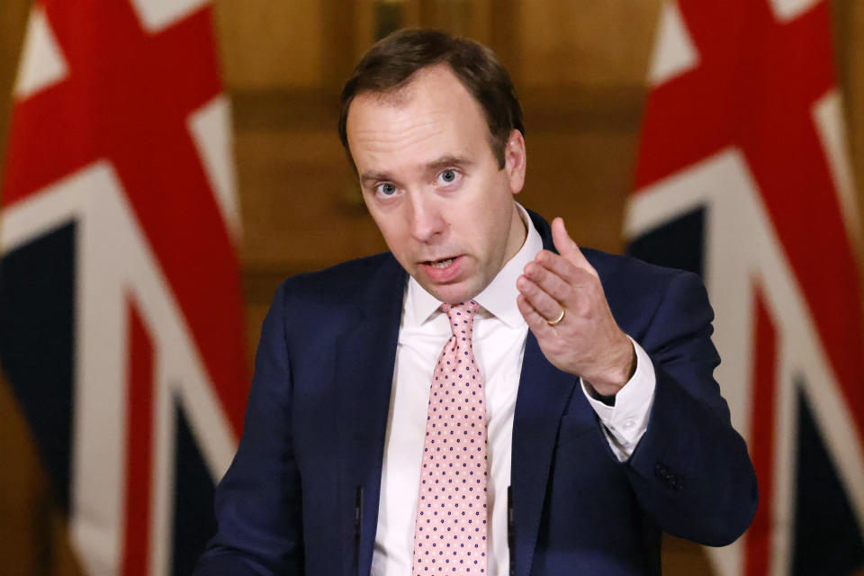 Britain's Health Secretary Matt Hancock takes part in a coronavirus media briefing, in Downing Street, London, Monday, Dec. 14, 2020. London and its surrounding areas will be placed under Britain's highest level of coronavirus restrictions beginning Wednesday as infections rise rapidly in the capital, the health secretary said Monday, adding that a new variant of the virus may be to blame for the spread. (Tolga Akmen/Pool Photo via AP)