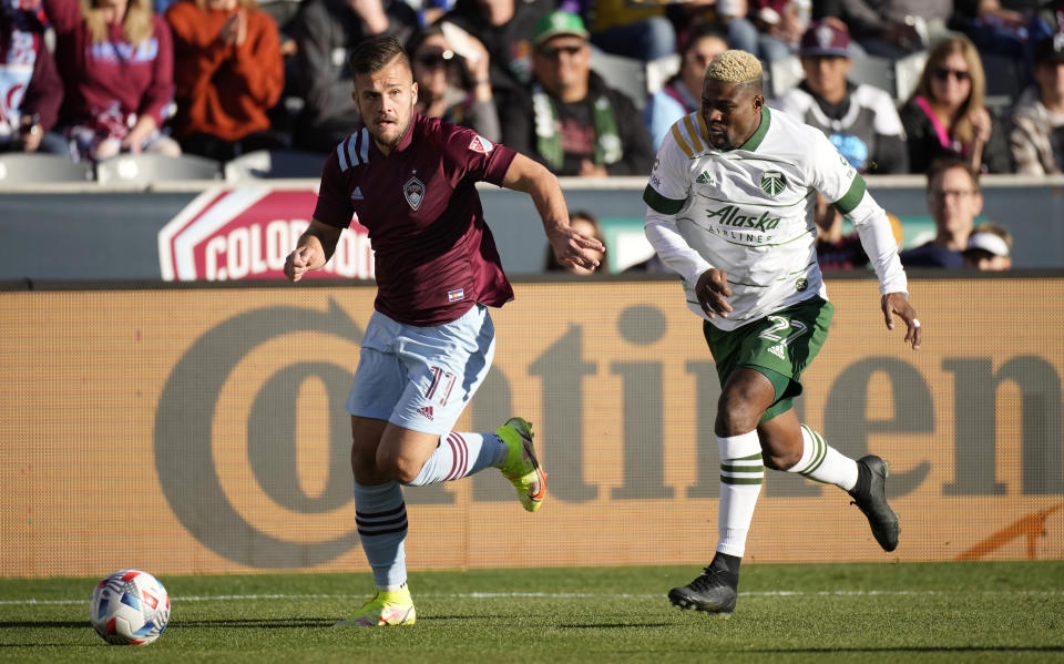 Colorado Rapids forward Diego Rubio, left, dribbles as Portland Timbers forward Dairon Asprilla chases in the first half of an MLS Western Conference semifinal playoff soccer match, Thursday, Nov. 25, 2021, in Commerce City, Colo. (AP Photo/David Zalubowski)