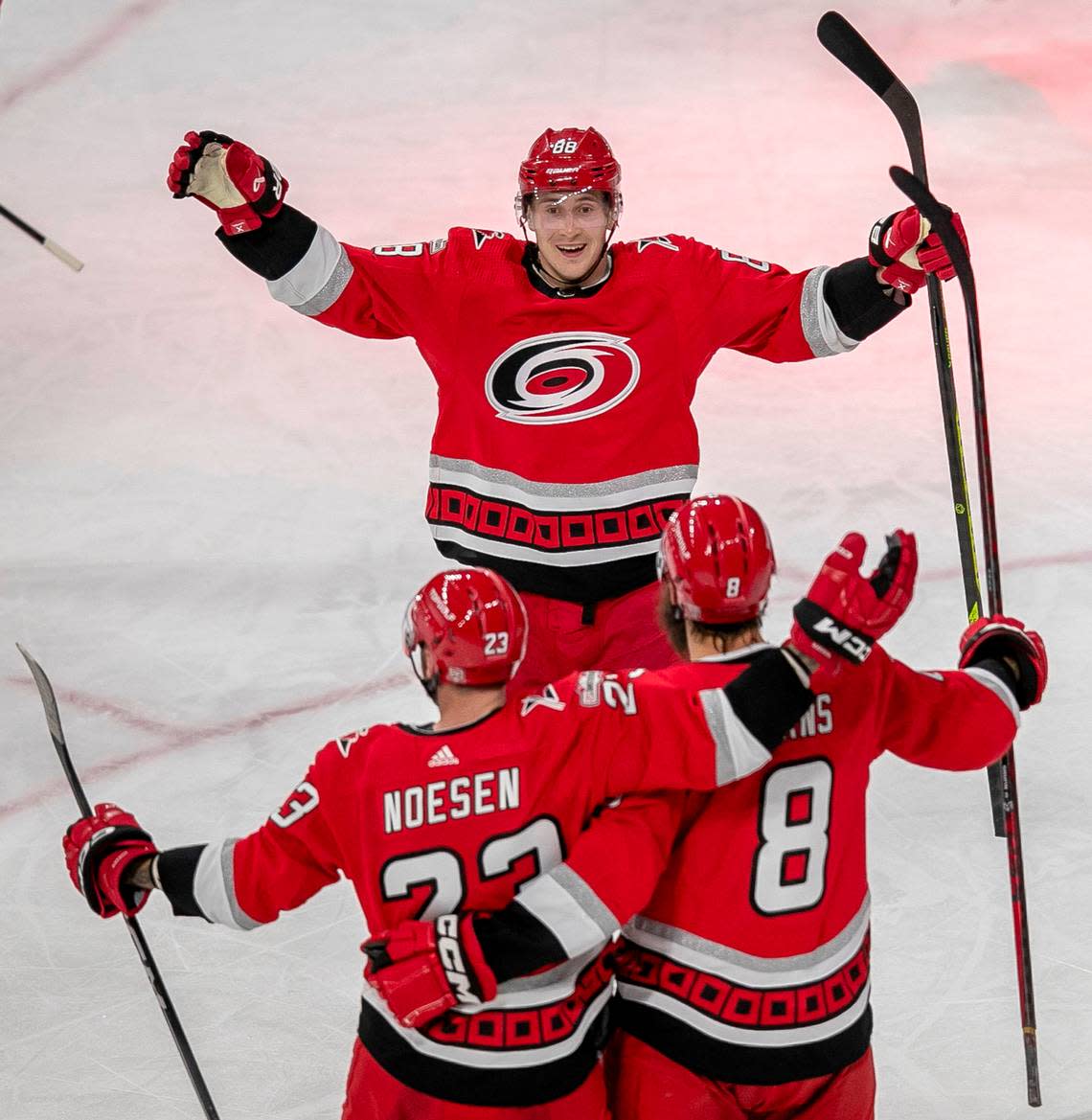 Carolina Hurricanes’ Stefan Noesen (23) celebrates with Brent Burns (8) and Martin Necas (88) after scoring in the second period to take a 2-0 lead during Game 2 of their Stanley Cup series on Wednesday, April 19, 2023 at PNC Arena in Raleigh, N.C.