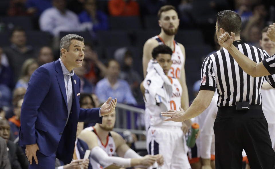 Virginia coach Tony Bennett discusses a call with an official during the second half of an NCAA college basketball game against Florida State in the Atlantic Coast Conference tournament in Charlotte, N.C., Friday, March 15, 2019. (AP Photo/Chuck Burton)