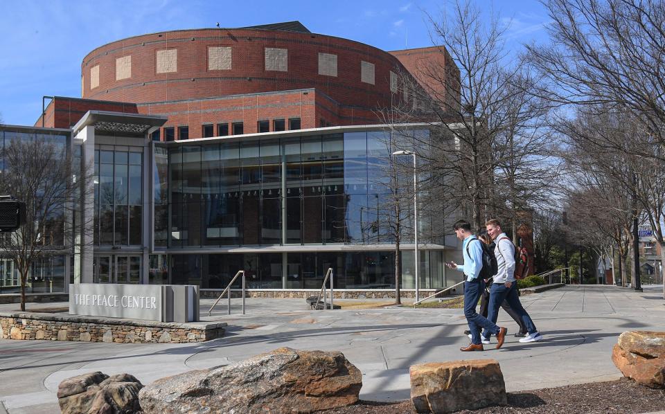 People walk by the Peace Center at 300 South Main Street in downtown Greenville, S.C.