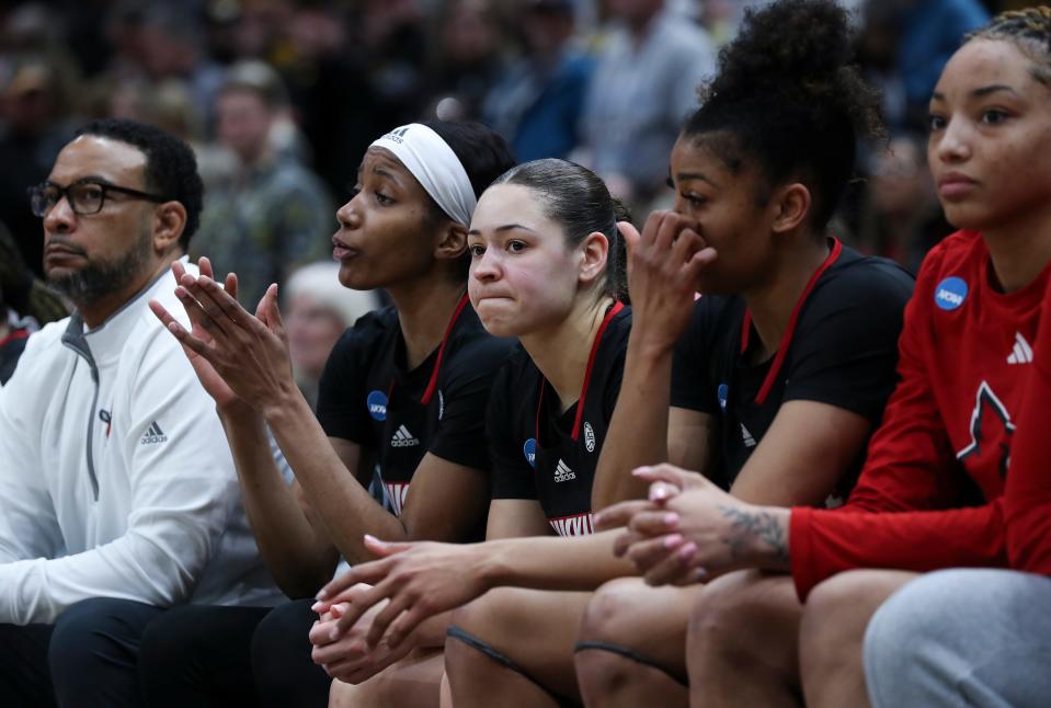 U of L’s Mykasa Robinson (5), center, was dejected on the bench during the closing seconds of their 97-83 loss to Iowa in the Elite 8 tournament at the Climate Pledge Arena in Seattle, W. on Mar. 26, 2023.  