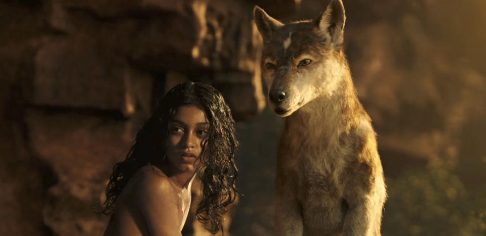 This image released by Netflix shows Rohan Chand as Mowgli, left, and the character Nishi, voiced by Naomie Harris, in a scene from the film, "Mowgli: Legend of the Jungle," streaming on Netflix on Friday. (Netflix via AP)