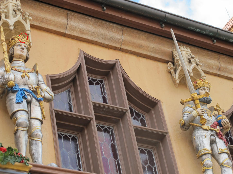 Mickey adorns the crown of the statue on the left. 