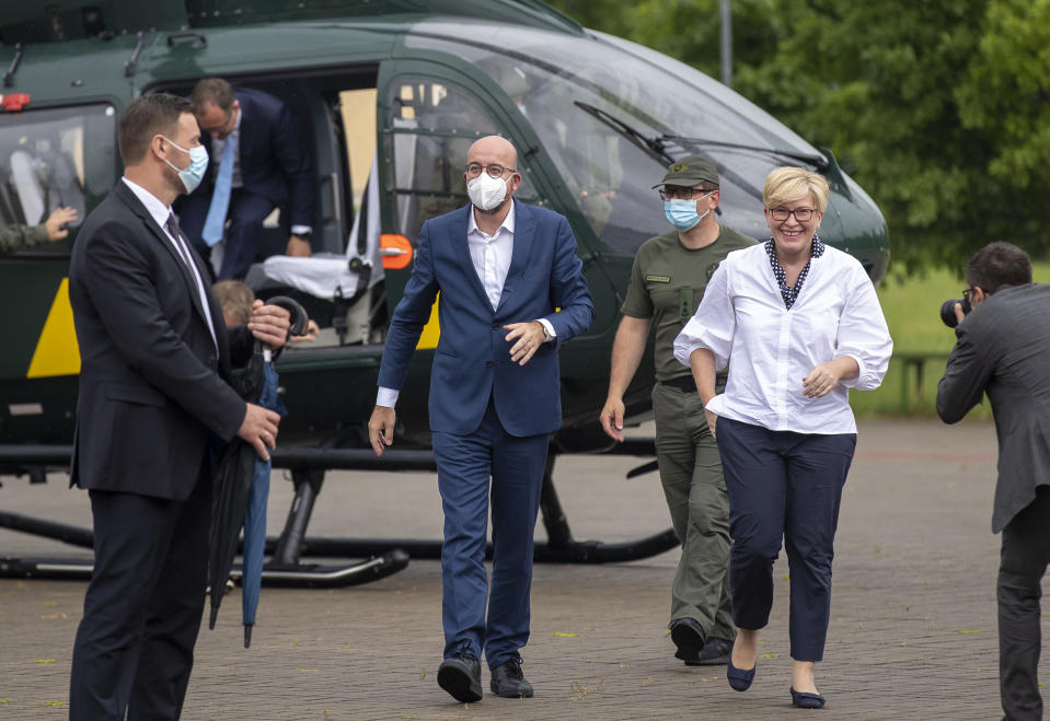 European Council President Charles Michel, left, and Lithuania's Prime Minister Ingrida Simonyte arrive at the Border Guard School near Lithuanian-Belarusian border, near the village Medininkai, some 25 km (24 miles) east of the capital Vilnius, Lithuania, Tuesday, July 6, 2021. (AP Photo/Mindaugas Kulbis)