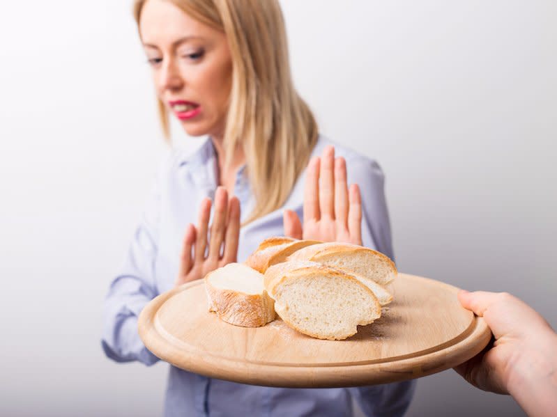 Woman pushing away bread