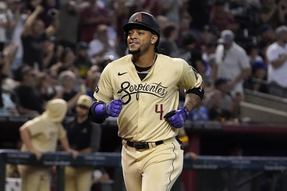 Arizona Diamondbacks' Ketel Marte smiles as he runs to home plate after hitting a two-run home run against the Chicago Cubs during the sixth inning of a baseball game Sunday, Sept. 17, 2023, in Phoenix. (AP Photo/Darryl Webb)