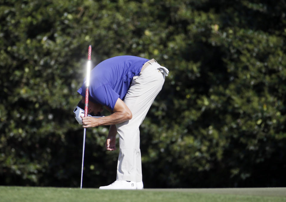 Adam Scott, of Australia, reacts after missing a birdie putt on the 11th hole during the third round of the Masters golf tournament Saturday, April 12, 2014, in Augusta, Ga. (AP Photo/Darron Cummings)