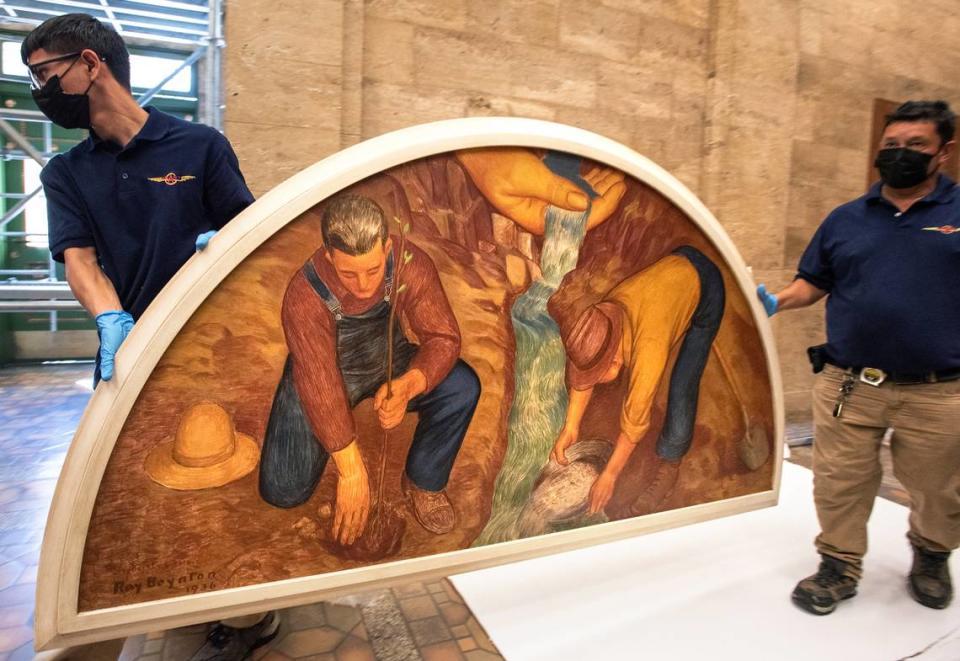 “Symbol of Water and Wealth” by Ray Boynton is returned to its home at the El Viejo Building, the former downtown Post Office, in Modesto, Calif., on Friday, July 22, 2022. The oil on masonite painting was one of nine murals commissioned during the 1930’s era arts program.