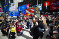 Protesters take a knee as a sign of unity and chant during a solidarity march for George Floyd, Tuesday, June 2, 2020, in Times Square, New York. (AP Photo/Eduardo Munoz Alvarez)