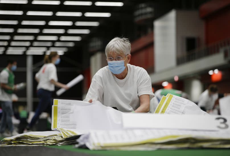 Ballot papers are being sorted prior to the counting of votes in general election in Amsterdam.