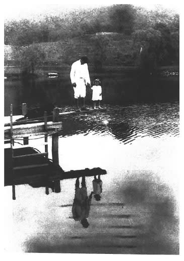 An archival image of a man and a girl down at the property’s lake. Willow Lake Farm