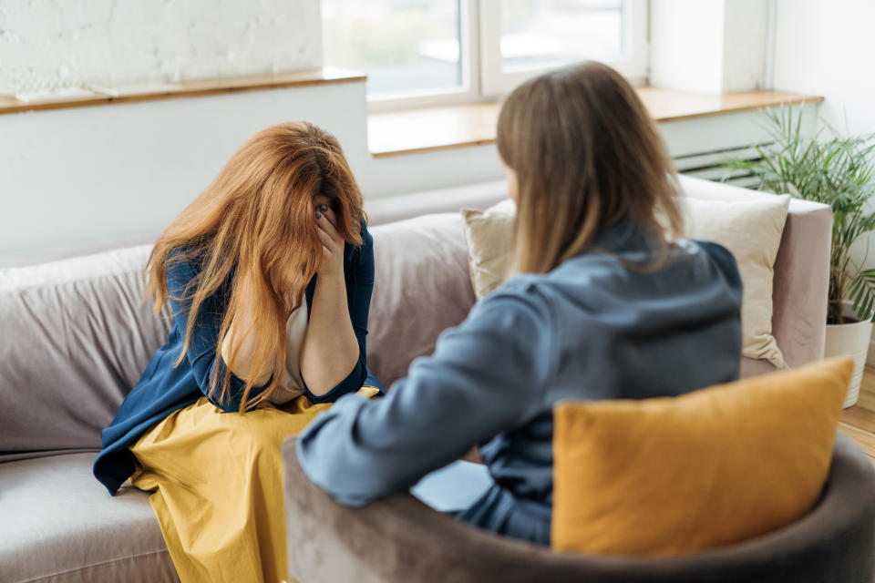 two people sitting across one another