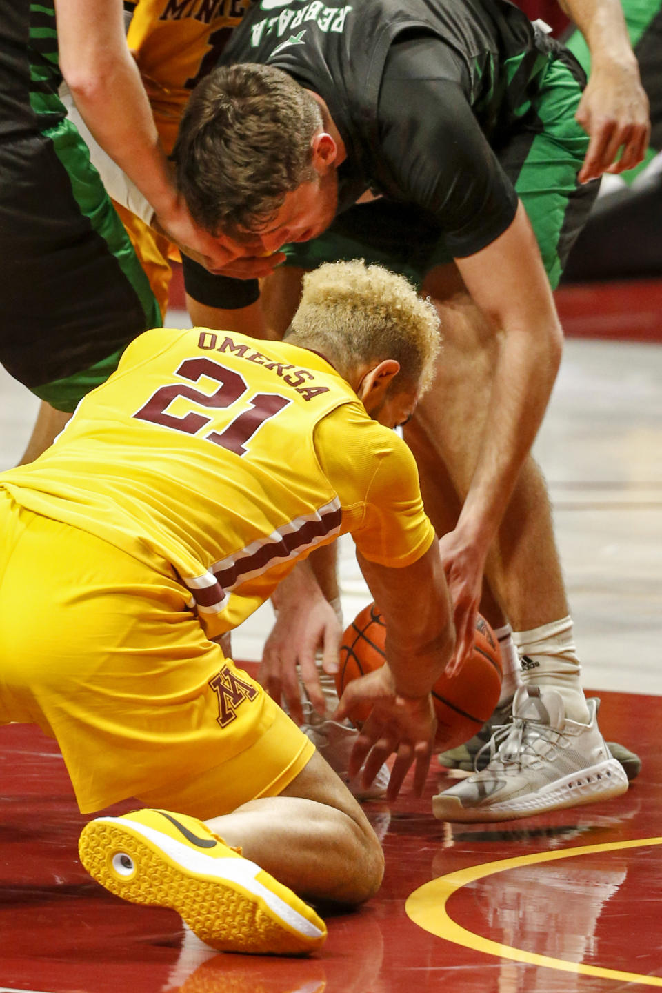 North Dakota forward Filip Rebraca (12) battles with Minnesota forward Jarvis Omersa (21) for the ball in the first half of an NCAA college basketball game Friday, Dec. 4, 2020, in Minneapolis. (AP Photo/Bruce Kluckhohn)