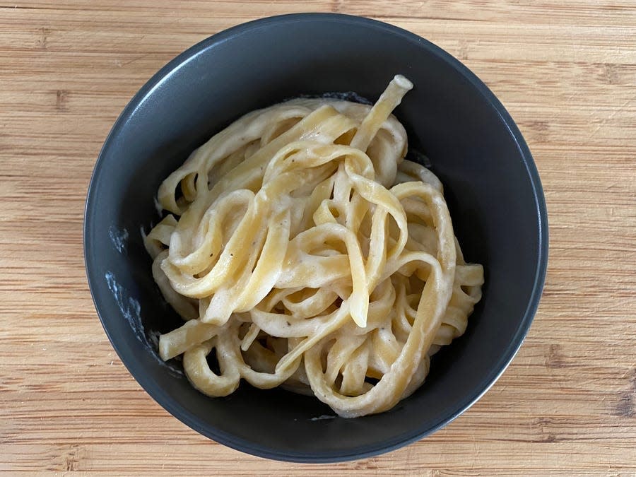 Katie Lee Biegel's fettuccine Alfredo in a black bowl.