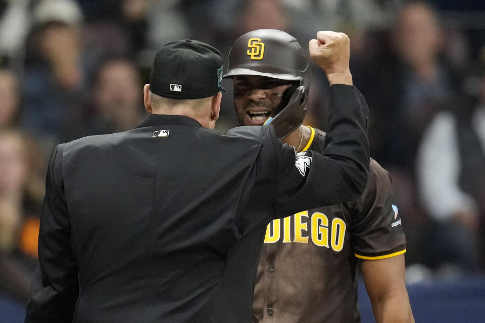 San Diego Padres' Xander Bogaerts, right, argues with home plate umpire Andy Fletcher after striking out during the eighth inning of a baseball game against the Los Angeles Dodgers at the Gocheok Sky Dome Thursday, March 21, 2024, in Seoul, South Korea. (AP Photo/Lee Jin-man)